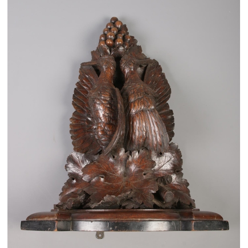 175 - A good pair of carved wall brackets decorated with hanging game birds. One marked to the back for R ... 