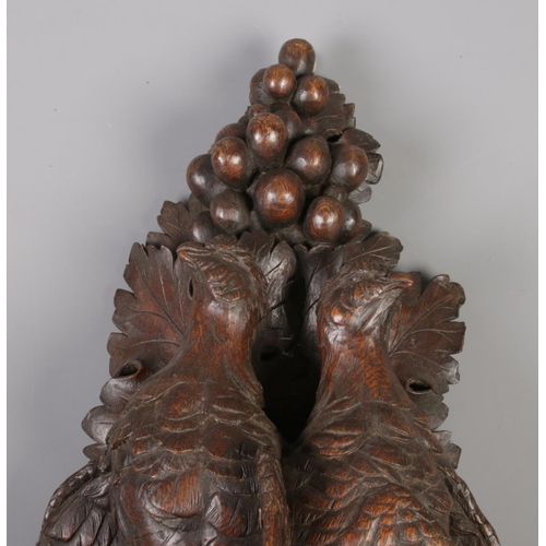 175 - A good pair of carved wall brackets decorated with hanging game birds. One marked to the back for R ... 