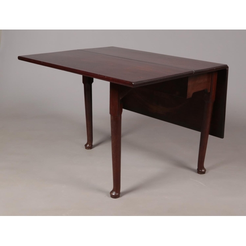 176 - A Georgian mahogany drop leaf dining table.