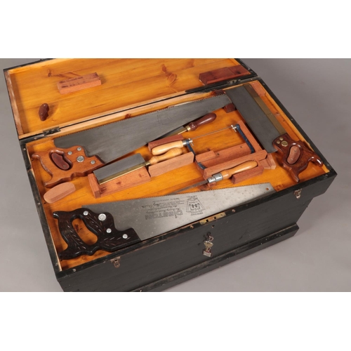 194 - A painted carpenters chest with contents of various good quality tools. Includes planes, chisels, sa... 