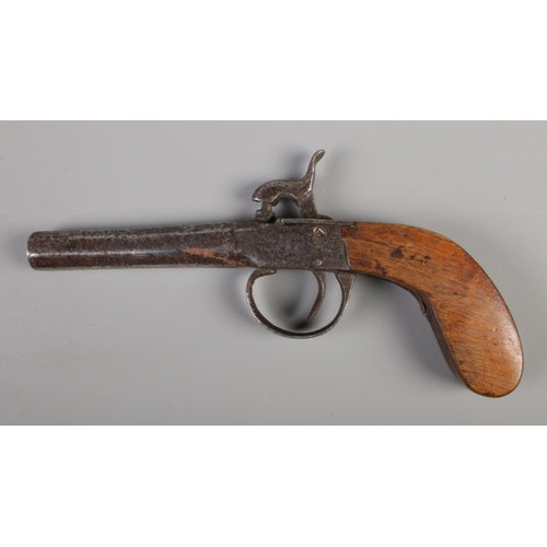 57 - A cased percussion cap pistol with accessories. Overall length 7.5inch.