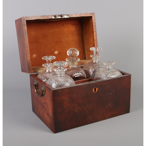 70 - A Georgian mahogany tantalus box with five antique glass decanters. Height 21.5cm, Width 27cm, Depth... 