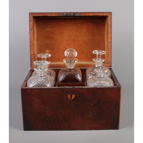 70 - A Georgian mahogany tantalus box with five antique glass decanters. Height 21.5cm, Width 27cm, Depth... 