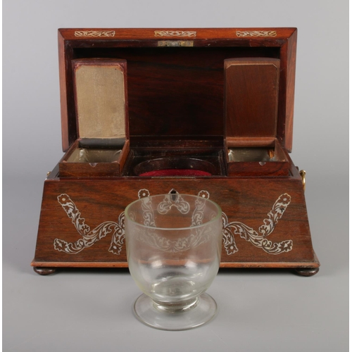 72 - A Victorian tea caddy of sarcophagus form, having mother of pearl inlay and brass loop handles.