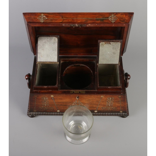 73 - A Victorian rosewood tea caddy of sarcophagus form, having mother of pearl inlay and wooden loop han... 