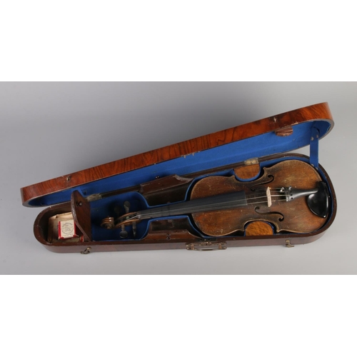 80 - An antique one piece back violin housed in inlaid walnut case. Bearing label 'Nicolaus Amatus fecit ... 