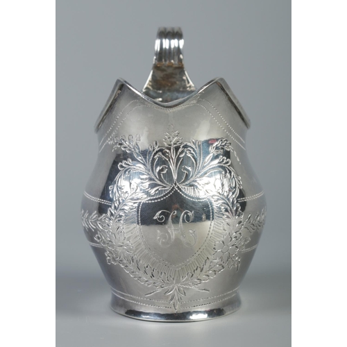 92 - A George III silver cream jug with engraved decoration. Assayed London 1803 by Samuel & Edward Daven... 