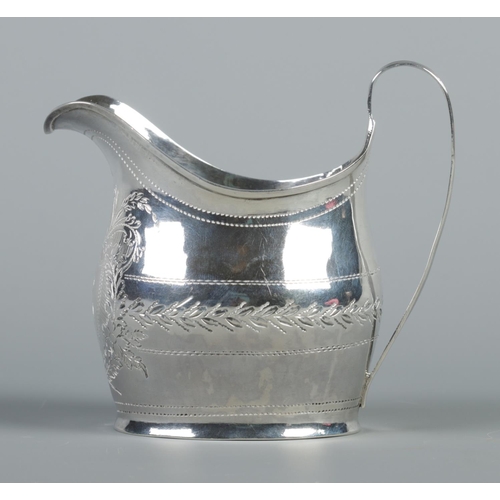 92 - A George III silver cream jug with engraved decoration. Assayed London 1803 by Samuel & Edward Daven... 