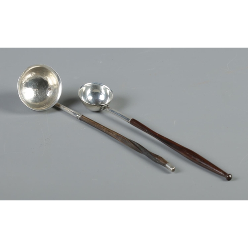 96 - Two Georgian silver toddy ladles. The larger bowled example having twisted whale bone handle, the sm... 