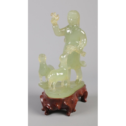 43 - A carved Jade figure group modelled as a young girl with two sheep, raised on hardwood stand. Boxed.