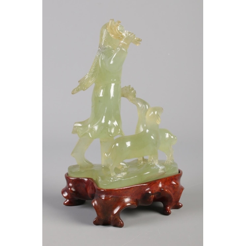 43 - A carved Jade figure group modelled as a young girl with two sheep, raised on hardwood stand. Boxed.