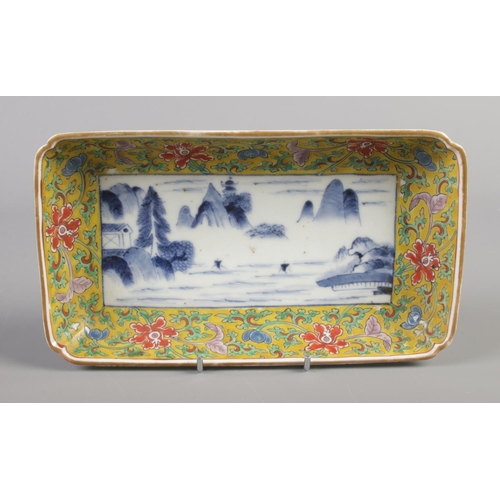 48 - A 19th century rectangular dish with borders decorated in coloured enamels and landscape scene to ce... 