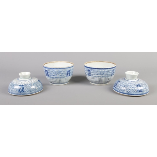 50 - A pair of eighteenth century Chinese rice bowls and covers, decorated in underglaze blue. 14.5cm