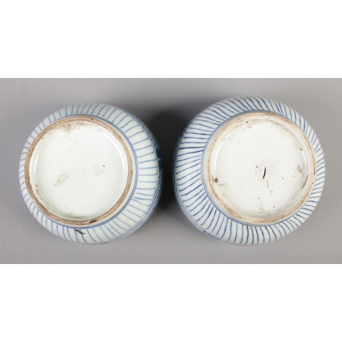 50 - A pair of eighteenth century Chinese rice bowls and covers, decorated in underglaze blue. 14.5cm