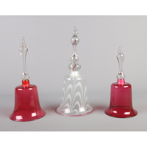 22 - Three Victorian glass bells. Includes marble swirl example and two cranberry coloured examples.