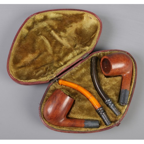 97 - A cased pair of Victorian smoking pipes, with wooden bowls and silver mounts. Assayed Birmingham 189... 