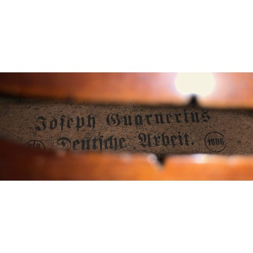 79 - A  19th century two piece back violin, labelled for Joseph Guarnerius dated 1886. In wooden case wit... 