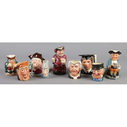 216 - Nine ceramic character jugs. Includes Royal Doulton examples; The Graduate, Honest Measure, Falstaff... 