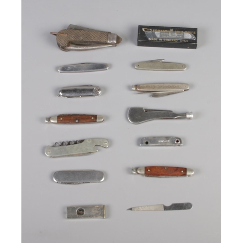 234 - A collection of pen knives including engraved commemorative examples and footprint mini knife.