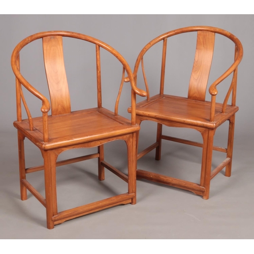 542 - A pair of Chinese hardwood horseshoe chairs.