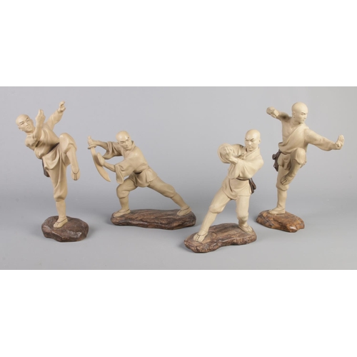 257 - A set of four oriental Mudman style clay figures, each modelled in a different martial arts pose.