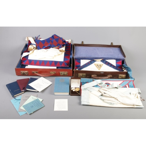 259 - Two small suitcases containing Masonic uniforms, pin badges with accessories. Also, rule books and g... 