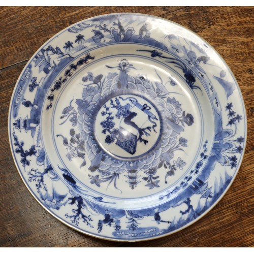 52 - An 18th century Chinese dish decorated in underglaze blue with landscapes and figures. Diameter 25.5... 