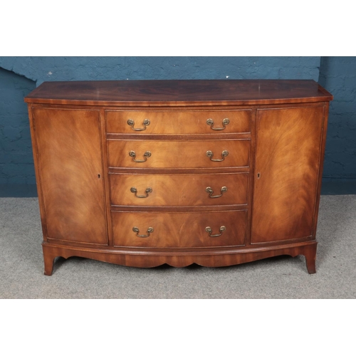 569 - A mahogany bow front sideboard with four central drawers, two cupboards and semi-fitted interior. Di... 