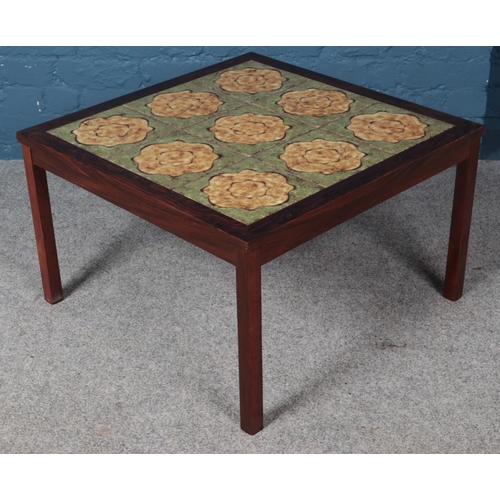 576 - A tile top coffee table. (42cm x 70cm x 70cm)