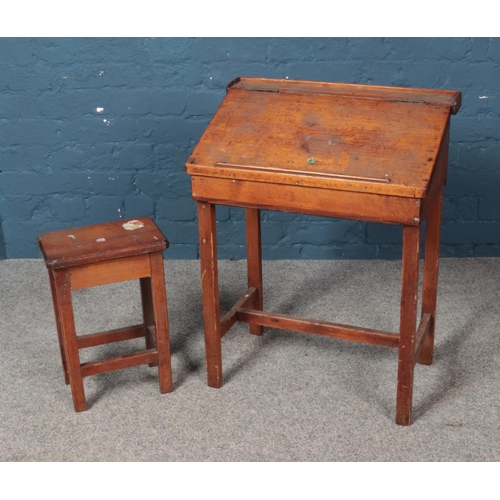 577 - A traditional child's school desk with hinge top along with small stool.