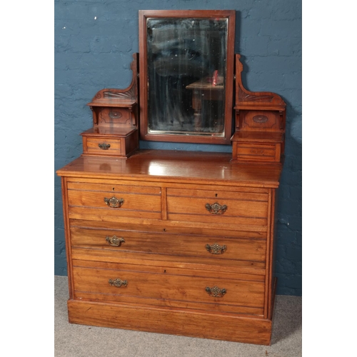 594 - An Edwardian carved mahogany  two piece bedroom suite. Comprising of mirror front wardrobe and dress... 