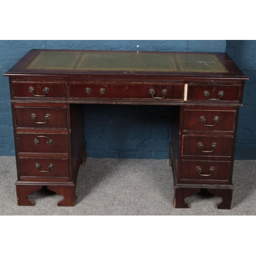 597 - A mahogany twin pedestal desk with leather inset top. (77cm x 121cm)