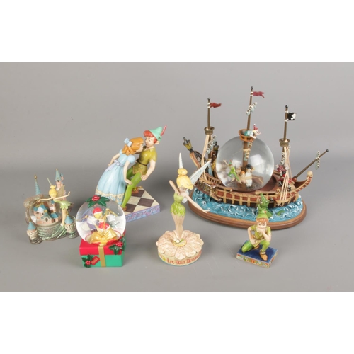 107 - A quantity of Disney's Peter Pan figures including Ship snow globe, Peter and Wendy, Tinkerbell etc.