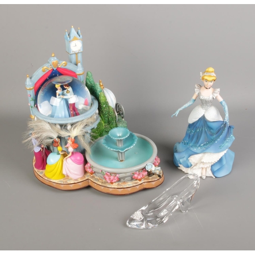 108 - A quantity of Disney's Cinderella figures including snow globe fountain, glass slipper and Cinderell... 