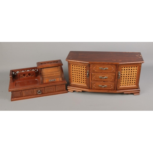 111 - Two decorative carved wooden jewellery boxes. Larger example featuring bergere detail on doors.