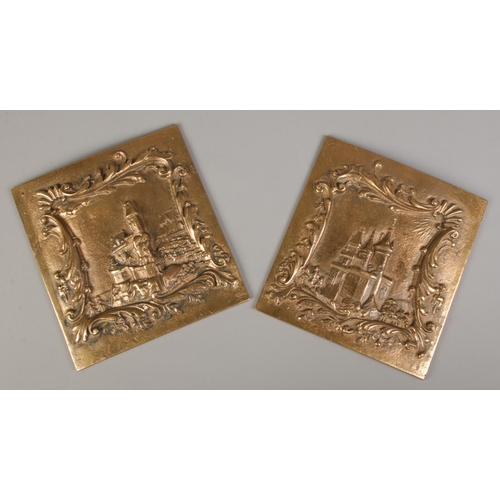 117 - A pair of cast bronze plaques, with scenes depicting Continental castles. 21.5cm x 20.5cm.