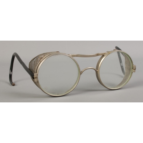 118 - A pair of WWII era safety glasses. Stamped 'Made in England' to side of the lens.