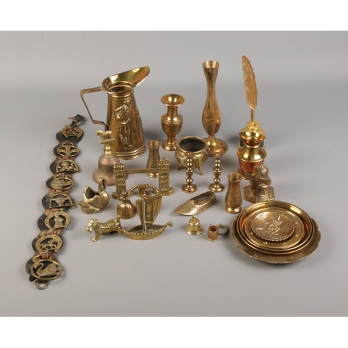 12 - A box of assorted brassware including decorative jug, plates, novelty cauldron and inkwell.