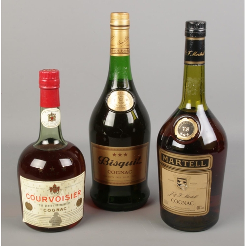 122 - Three full and sealed bottles of cognac. Includes Courvoisier, Martell and Bisquit.