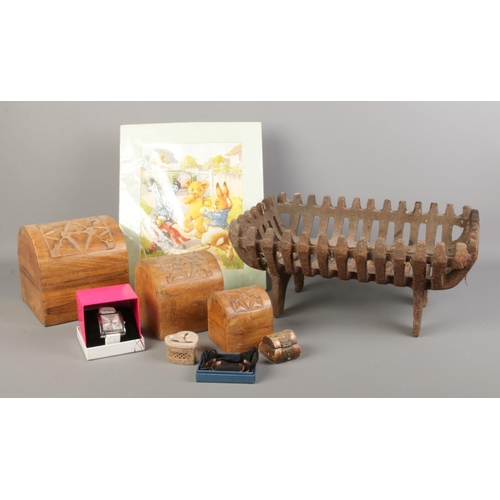 129 - An assortment of collectables, to include a trio of graduating hinged carved boxes, iron log basket ... 