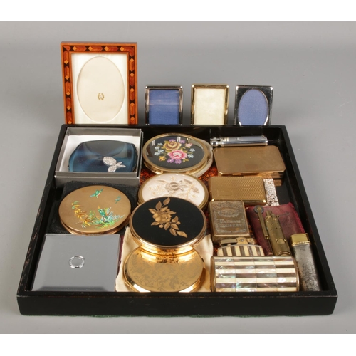 164 - A collection of lighters, compacts and miniature photo frames. To include Stratton and Ronson exampl... 