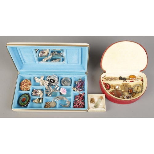 166 - Two boxes containing an assortment of dress jewellery, to include brooches, earrings and chains.