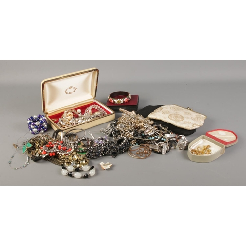 183 - A collection of costume jewellery, to include bangles, necklaces, earrings and evening bags.