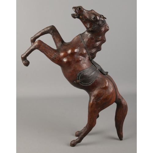 197 - A leather clad model of a rearing horse. Height 44cm.