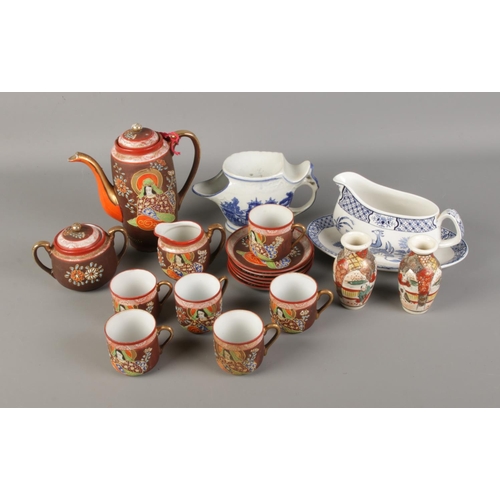 201 - A quantity of oriental ceramics including satsuma style jars, tea set and gravy boat.