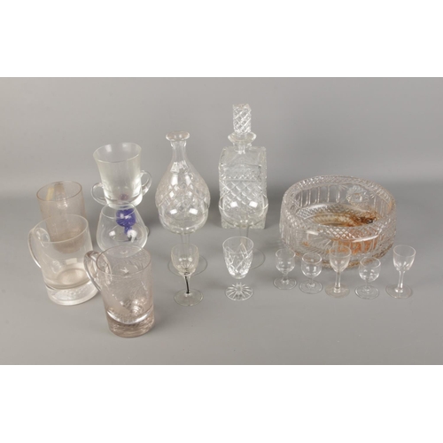 203 - A quantity of glassware including decanters, commemorative tankards and cut glass bowl.