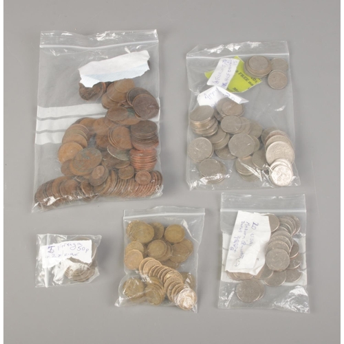 24 - A large quantity of assorted coins. Including Great British pennies, 3d bits, US and Canadian quarte... 