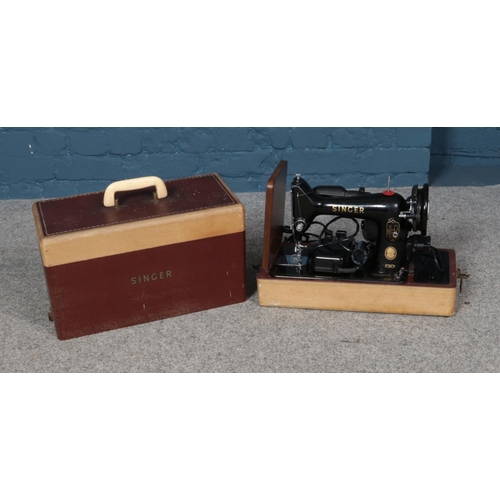 210 - A 1959 Singer sewing machine with complete case and pedal. Serial number K8298219.