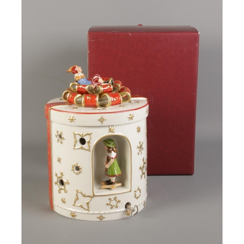 27 - A Villeroy & Boch jar with music box in the form of a Christmas present decorated with ribbon and to... 