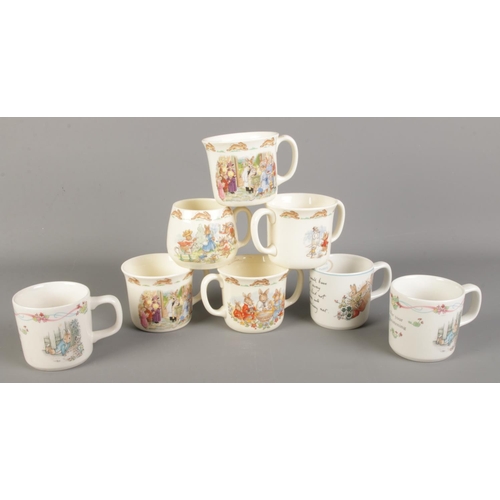 219 - A collection of Royal Doulton Bunnykins and Wedgwood Peter Rabbit mugs.